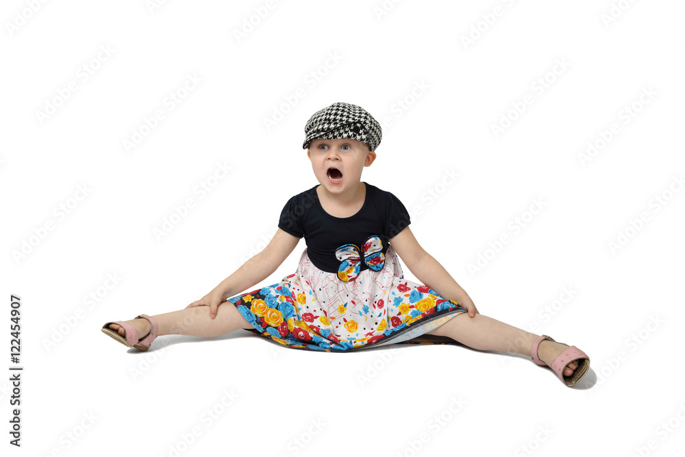 Little girl in cap sits on floor with legs spread apart and mouth open in  astonishment isolated on white backgroun Stock Photo | Adobe Stock