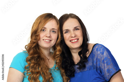 Redhead young girl and adult brunette woman together look forward isolated on white background - Mother and daughter - different beauty