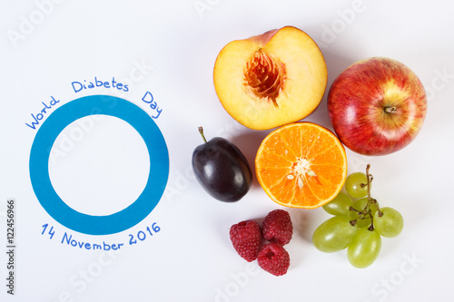 Symbol of world diabetes day and fresh fruits on white background