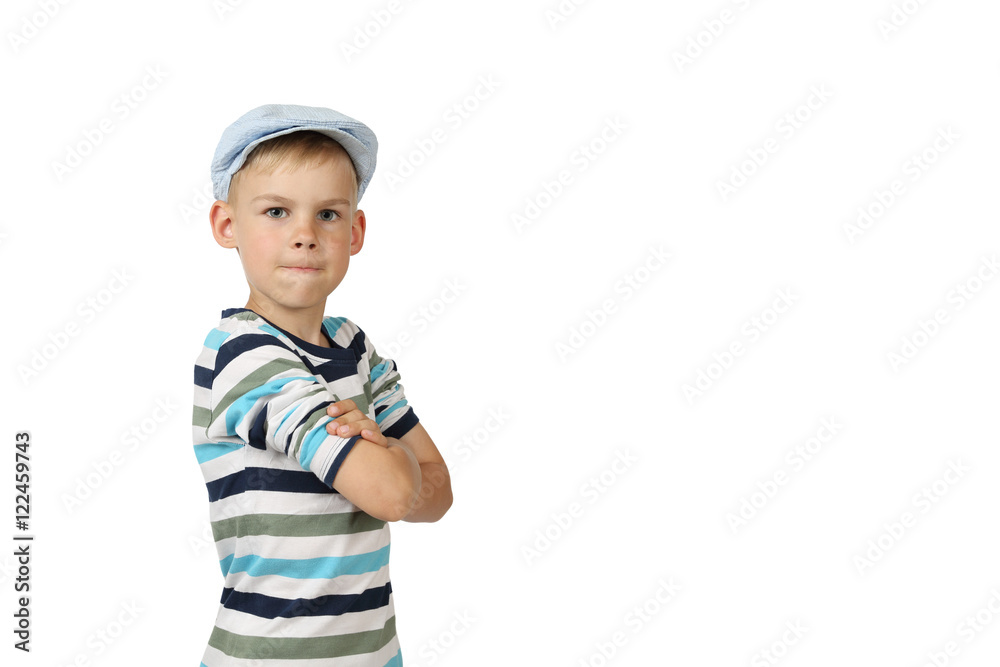 Cheeky serious boy in cap stays with hands crossed on chest and looking isolated on white background with copy space for text or advertising Cheeky serious boy in cap stays with hands crossed on chest and looking isolated on white background with copy space for text or advertising