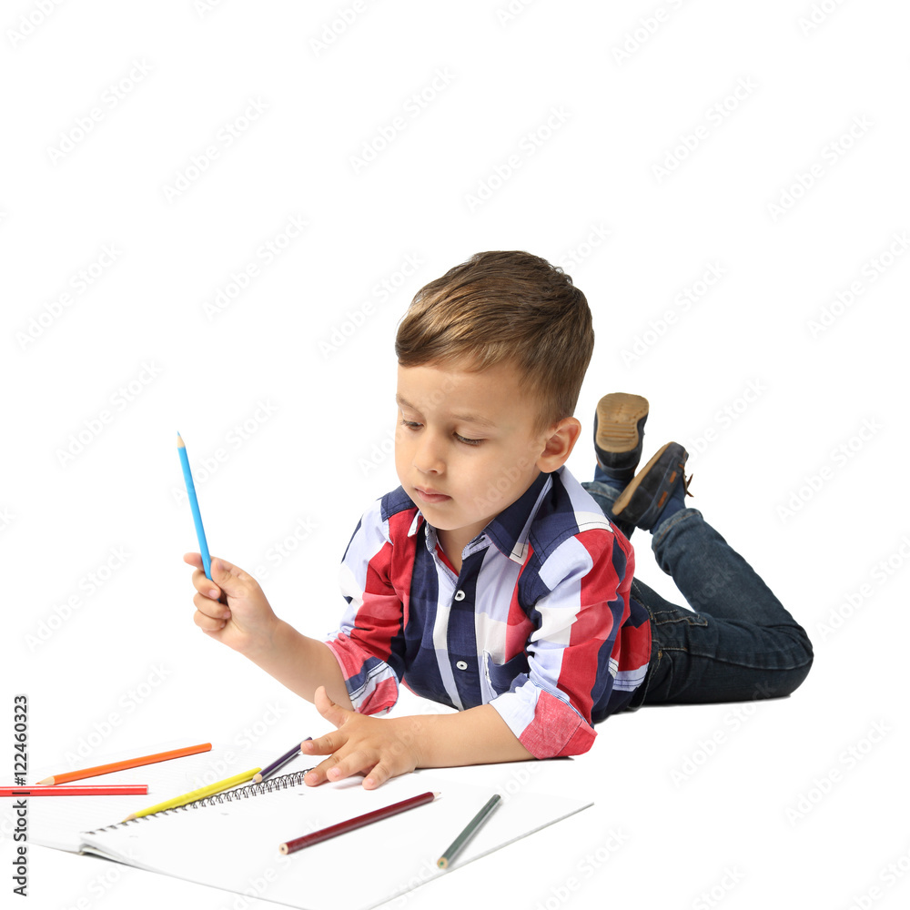 Little boy draws lying on floor isolated on white background Little boy draws lying on floor isolated on white background
