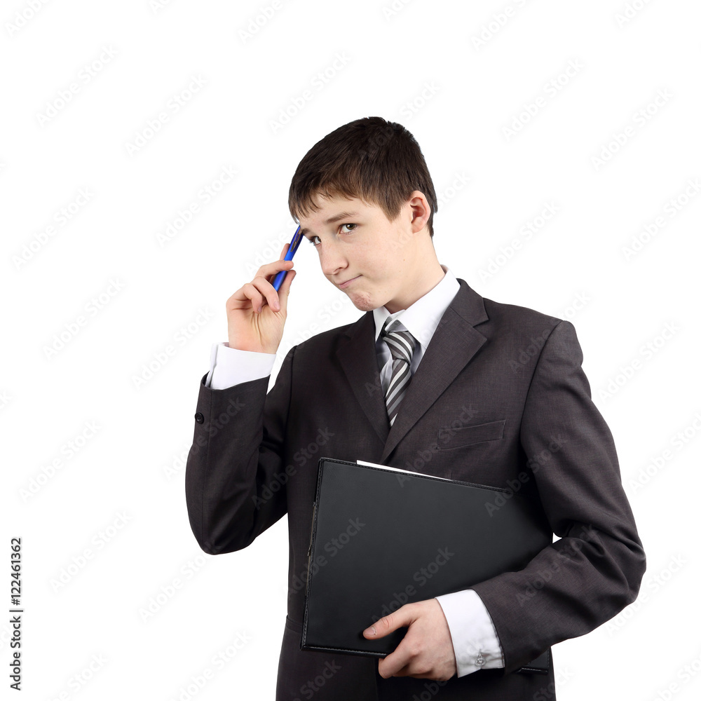 Young manager - Teenage boy in business suit with pen and folder in hands thinks isolated on white background Young manager - Teenage boy in business suit with pen and folder in hands thinks isolated on white background