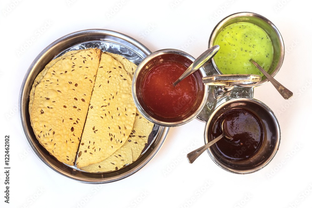 Indian bread served with traditional assortment of sauces Indian bread served with traditional assortment of sauces