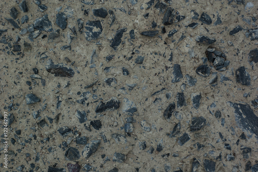 Abstract background: concrete and black granite stones.
