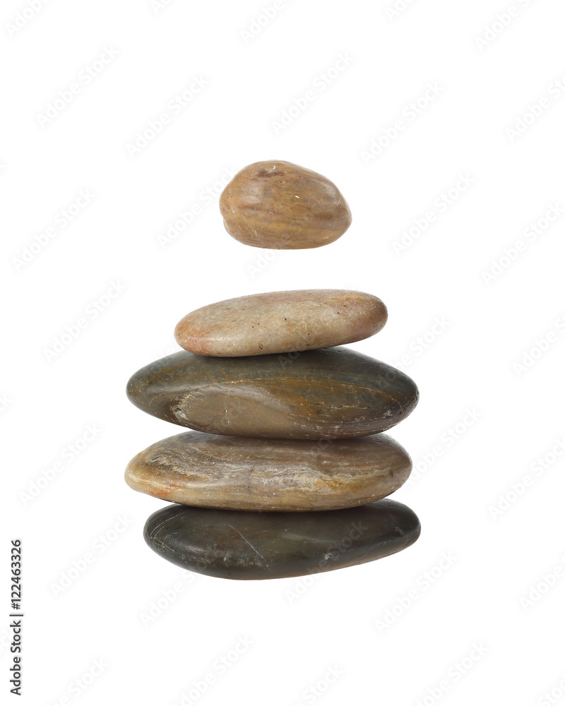Balanced zen stones in pyramid with one hanging in the air isolated on white background. Harmony and balance concept Balanced zen stones in pyramid with one hanging in the air isolated on white background. Harmony and balance concept