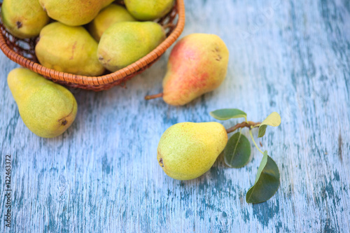 Fresh pears and half pear on the white wooden background. 