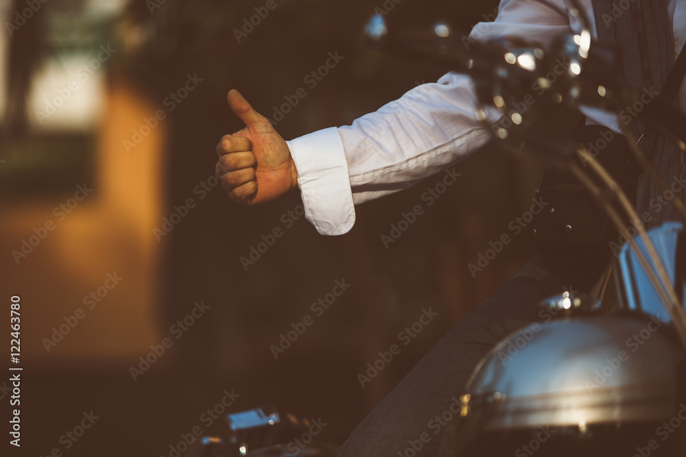 Man on bike showing thumb up Man on bike showing thumb up