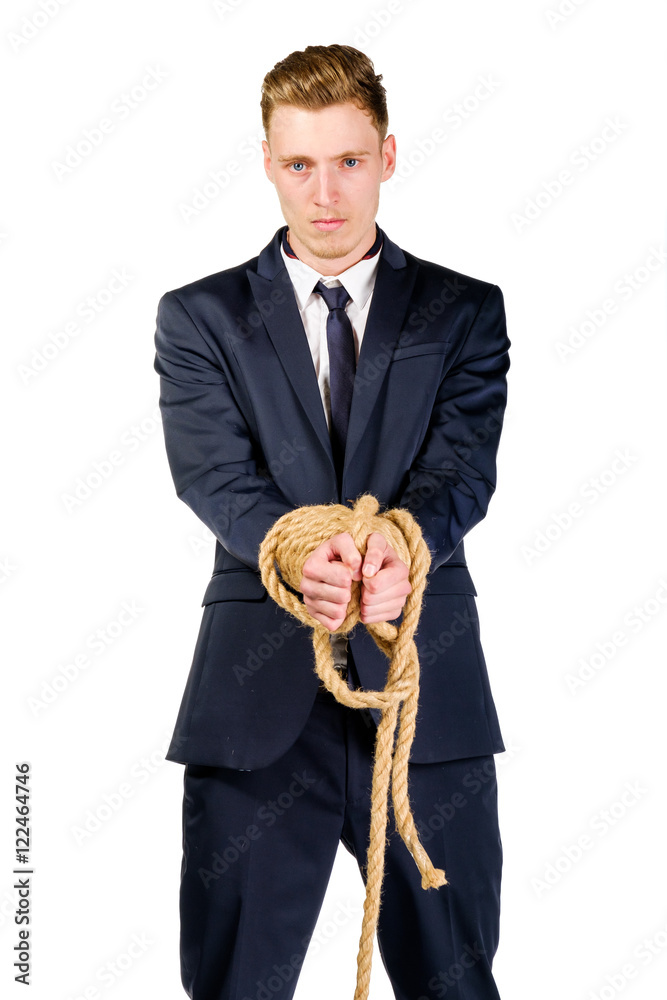 Young businessman in a suit tied up with rope Young businessman in a suit tied up with rope