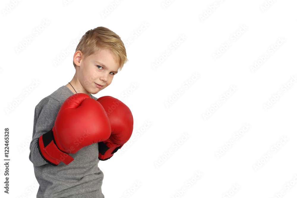 Boy in red gloves in a boxing stand isolated on white background with copy space for text - Sport advertising Boy in red gloves in a boxing stand isolated on white background with copy space for text - Sport advertising