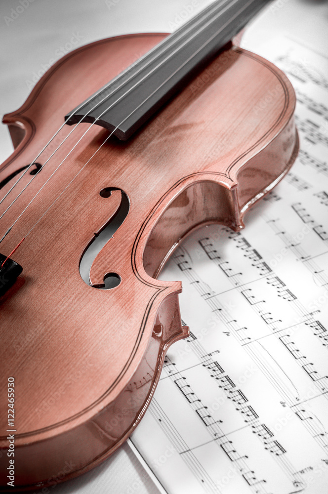 Fototapeta premium Old violin lying on the sheet of music, music concept