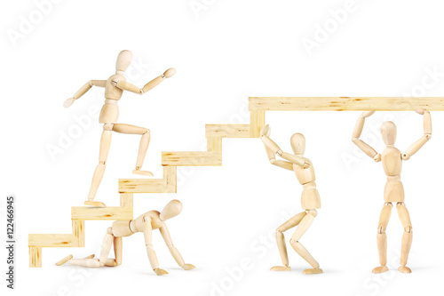 Men supporting stairs and other man going up. Abstract image with wooden puppets