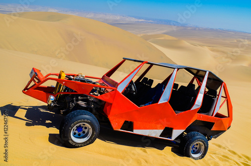 Dune buggy used to carry tourists practicing sand-boarding on the dunes in Huacachina desert, Peru