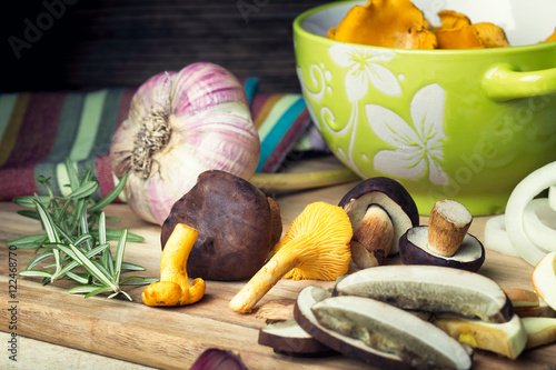 Sliced boletus with chanterelle and onion. Cooking musrooms photo