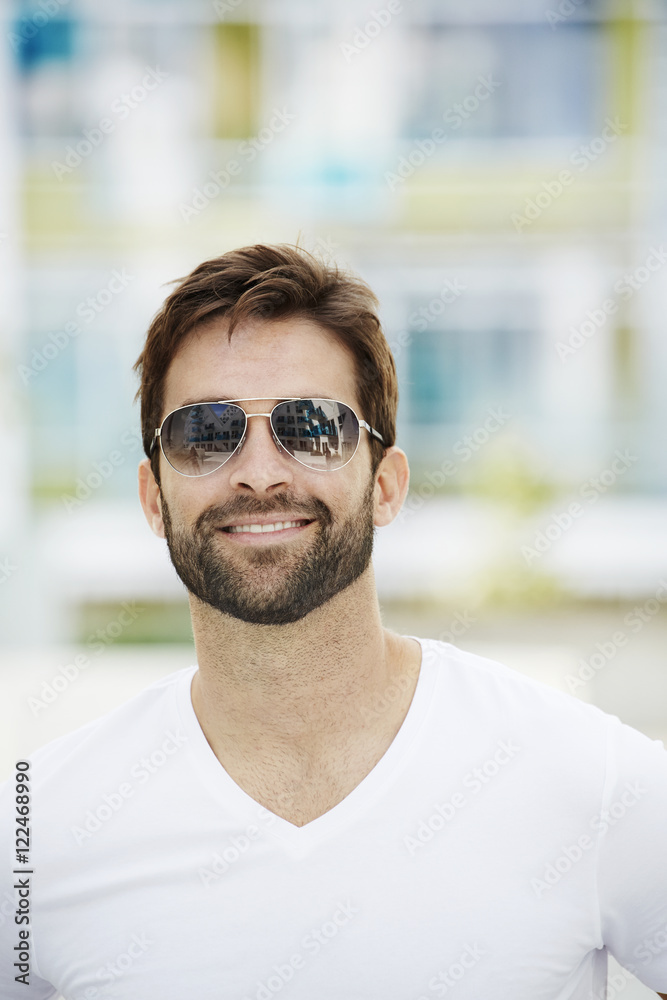 Happy guy in white t-shirt and sunglasses