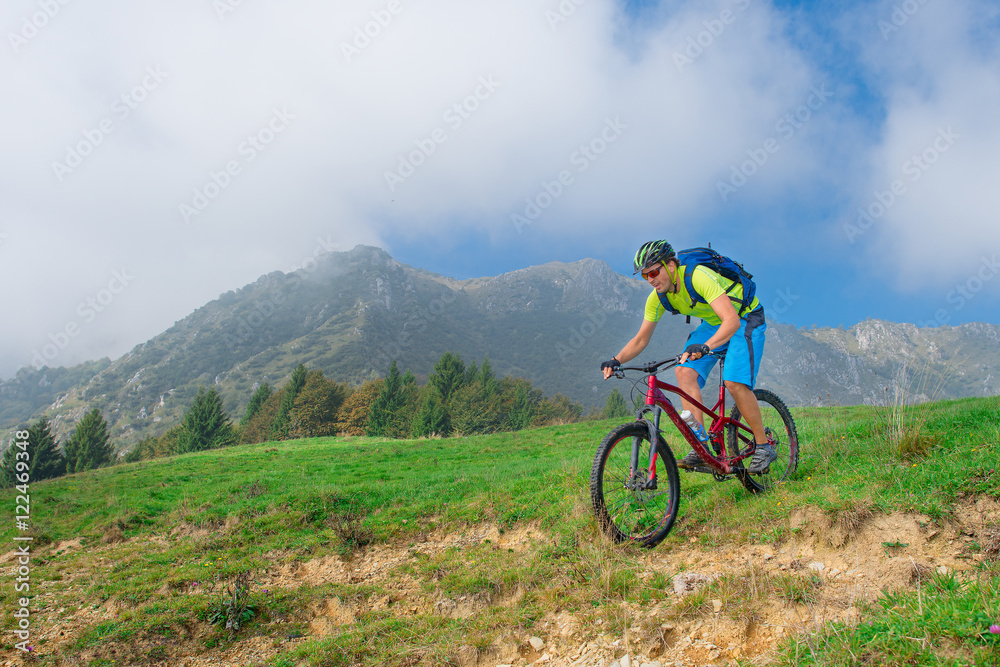 A young male riding a mountain bike outdoor