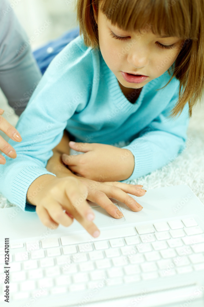 Little girl typing on laptop Little girl typing on laptop