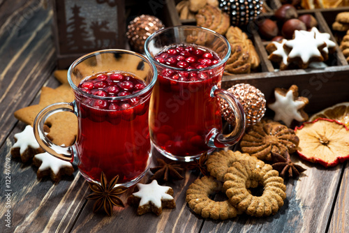 Christmas hot cranberry tea and cookies on dark background