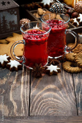 Christmas hot cranberry tea and cookies and dark background