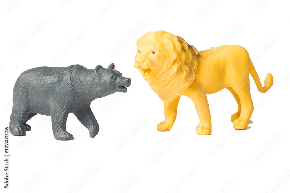 Toy lion and toy of black bear isolated white
