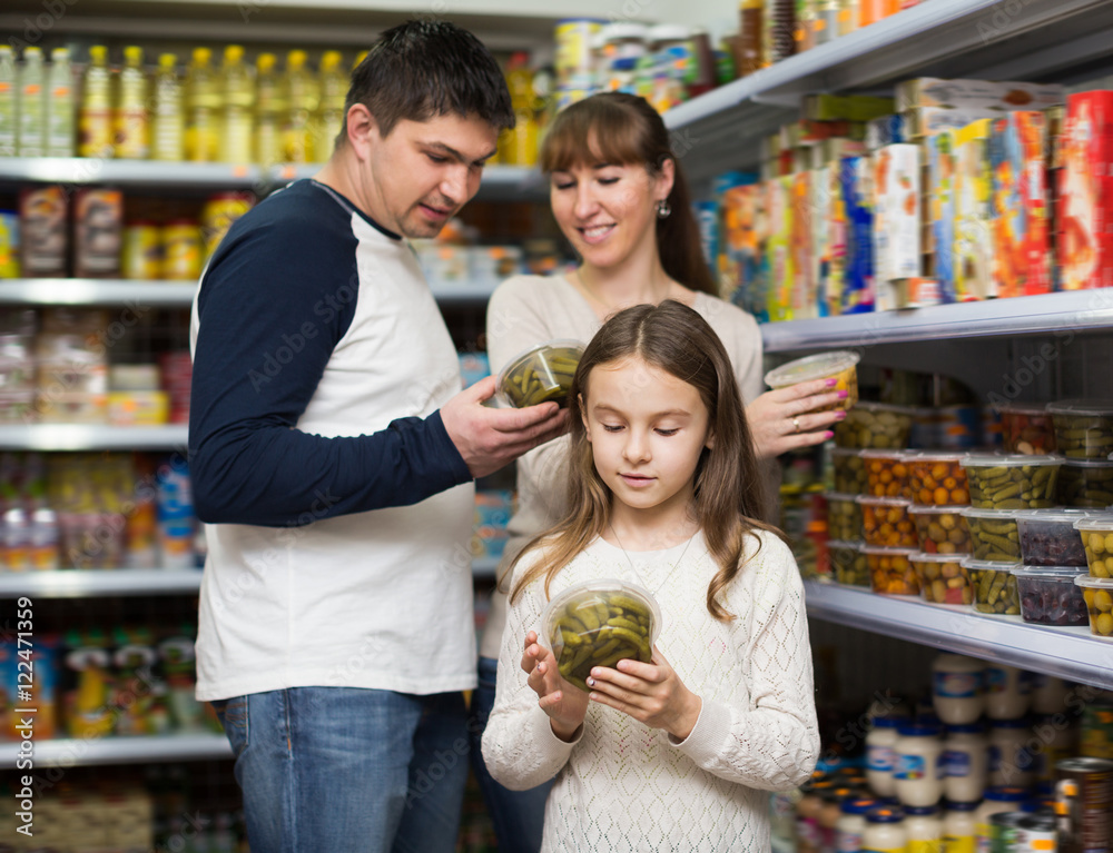 Family of three purchasing canned food