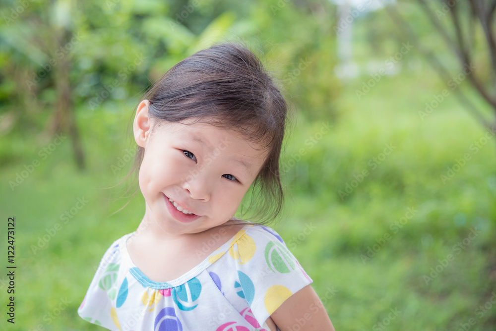 Little asian girl smiling in park Little asian girl smiling in park