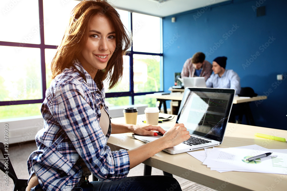 Photo woman working with new startup project in modern loft. Generic design notebook on wood table. Photo woman working with new startup project in modern loft. Generic design notebook on wood table.