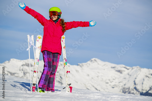 Girl standing with arms spreading wide open on the fresh powder