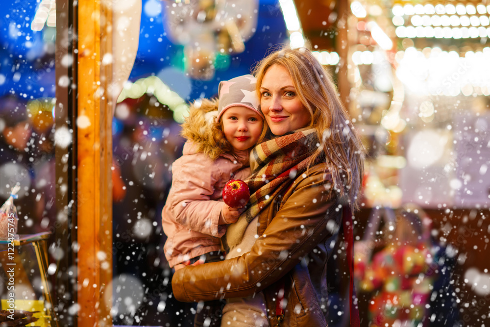 Mother and little daughter on Christmas market Mother and little daughter on Christmas market