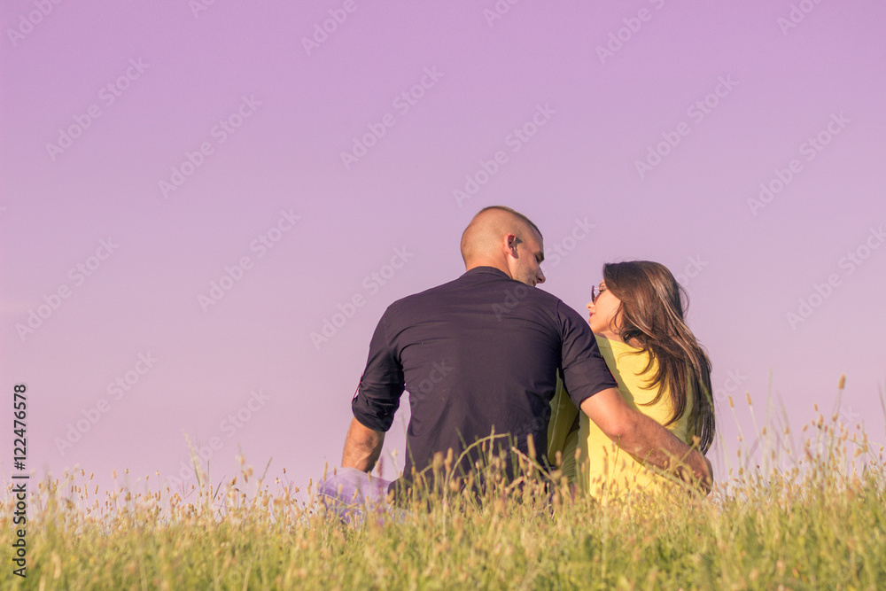 young couple hugging back rear view low angle sky grass young couple hugging back rear view low angle sky grass