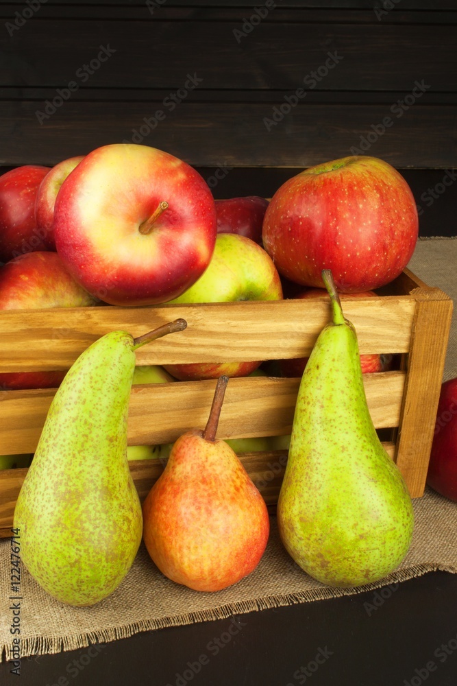 Pears and apples on wooden table. Autumn Fruits. Autumn harvest on the farm. A healthy diet for children.
