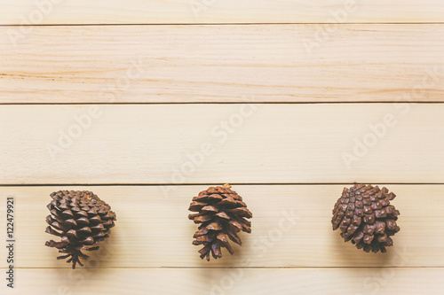 Top view pine cones on wood table background.