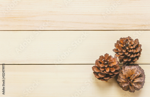 Top view pine cones on wood table background.