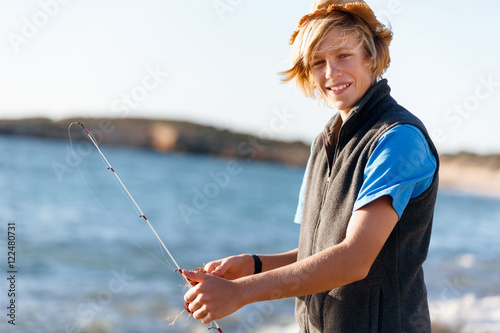 Teenage boy fishing at sea