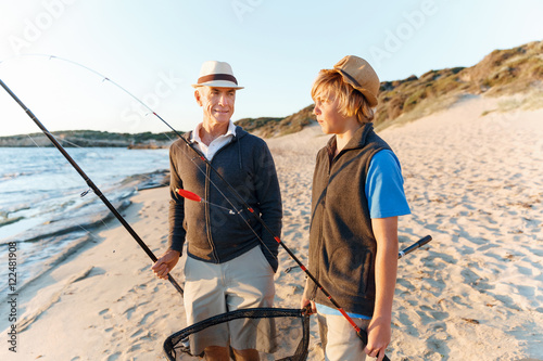 Senior man fishing with his grandson