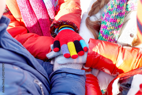 Heap of hands of children in winter gloves 