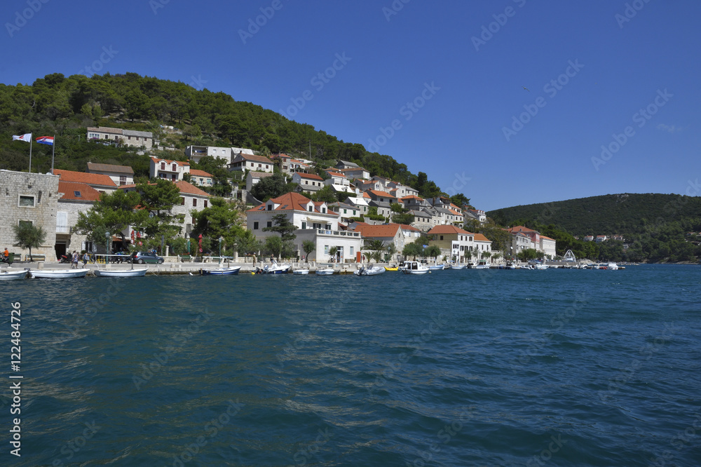 Little village Pučišća with clear blue water in foreground,picture from Island Brac in Croatia.