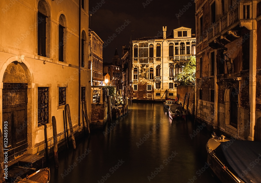 VENICE, ITALY - AUGUST 21, 2016: Famous architectural monuments, ancient streets and facades of old medieval buildings at night time close-up on August 21, 2016 in Venice, Italy.