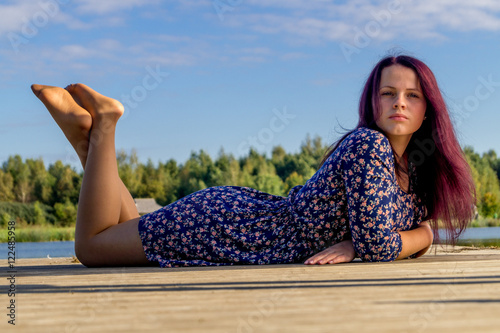 Fashion portrait of young sensual woman near river