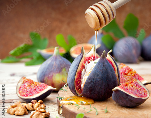 Fresh  figs with cheese and honey on wooden table.