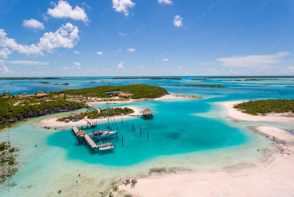 Aerial view of exotic island with authentic buildings and pier for yachts - obrazy, fototapety, plakaty 