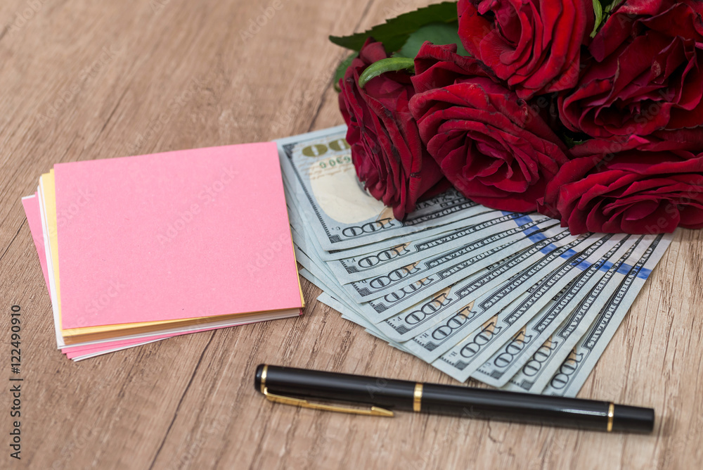 open notebook and pen with rose and dollar open notebook and pen with rose and dollar