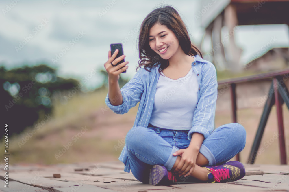 Fashionable Young Woman with her Mobile Phone.