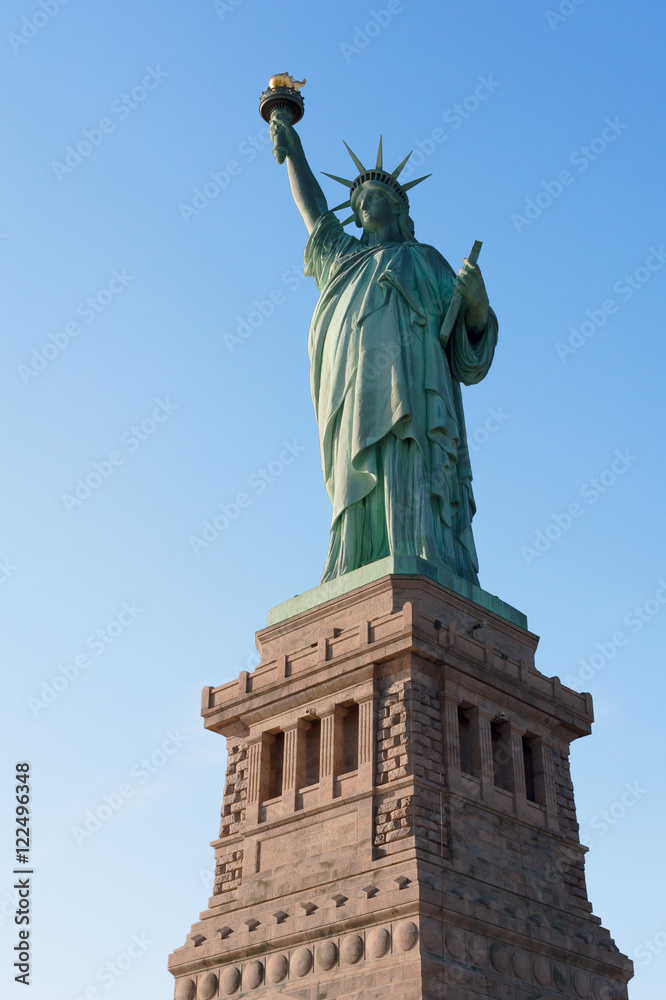 Statue of Liberty against blue sky in New York City, United States of America