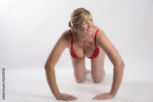 Middle aged woman exercising. A blond attractive woman doing press-ups photo