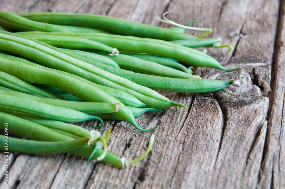 Fresh green beans on wooden table 