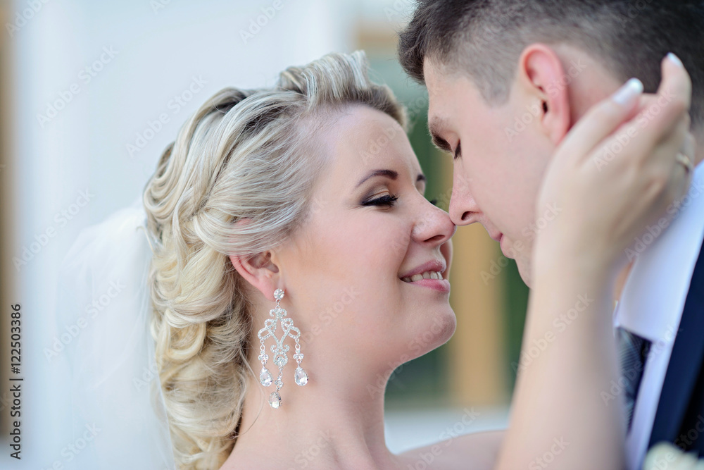 Wedding couple on the nature is hugging each other. Beautiful model girl in white dress. Man in suit. Beauty bride with groom. Female and male portrait. Woman with lace veil. Lady and guy outdoors Wedding couple on the nature is hugging each other. Beautiful model girl in white dress. Man in suit. Beauty bride with groom. Female and male portrait. Woman with lace veil. Lady and guy outdoors