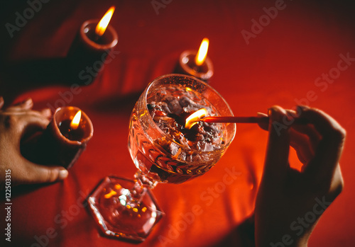 witch holds candle love spell on ritual photo