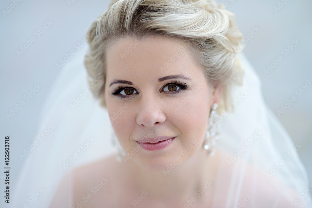 Beauty bride in bridal gown with lace veil on the nature. Beautiful model girl in a white wedding dress. Female portrait in the park. Woman with hairstyle. Cute lady outdoors Beauty bride in bridal gown with lace veil on the nature. Beautiful model girl in a white wedding dress. Female portrait in the park. Woman with hairstyle. Cute lady outdoors