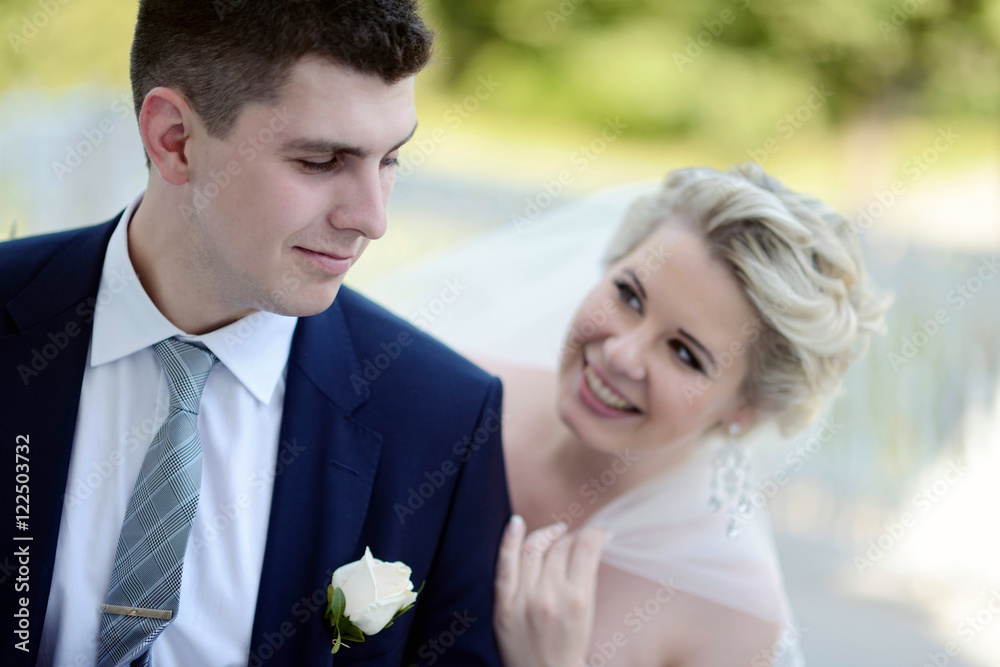 Wedding couple on the nature is hugging each other. Beautiful model girl in white dress. Man in suit. Beauty bride with groom. Female and male portrait. Woman with lace veil. Lady and guy outdoors Wedding couple on the nature is hugging each other. Beautiful model girl in white dress. Man in suit. Beauty bride with groom. Female and male portrait. Woman with lace veil. Lady and guy outdoors