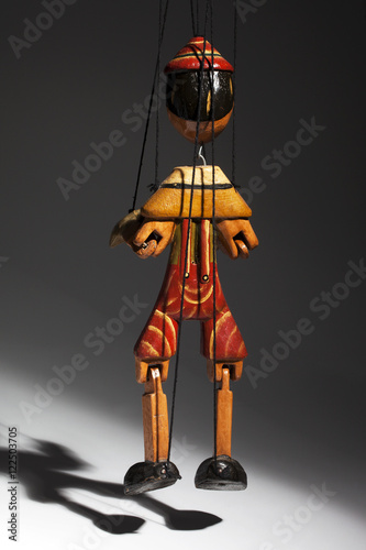 Pinocchio liar doll with big nose isolated on background
